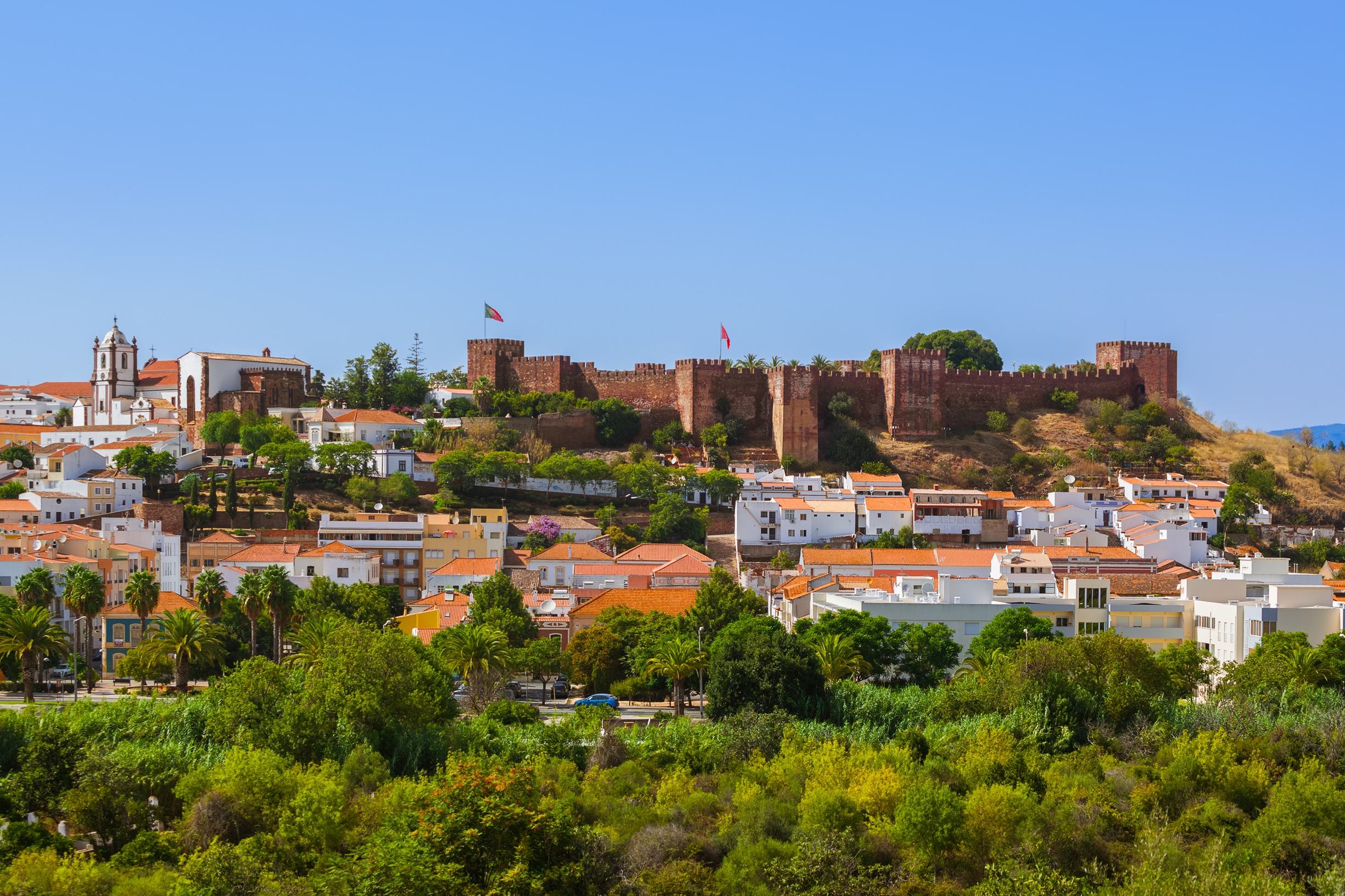 Historic castle above a town of white houses in the Algarve